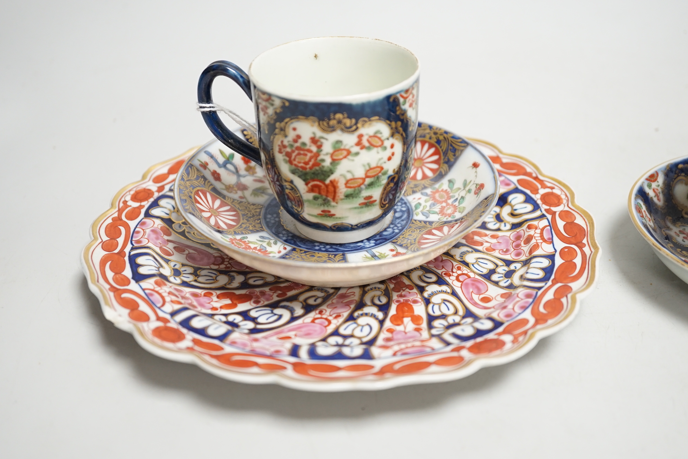 A Worcester kakiemon style scale blue trio, c.1770, a Worcester Queen Charlotte’s pattern plate, 19.5 cm and a Samson saucer in Worcester style